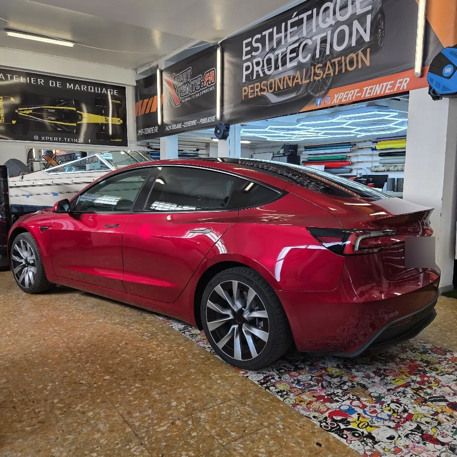 Profil arrière et lunette de la Tesla Model 3 Highland rouge. Profil arrière et lunette de la Tesla Model 3 Highland rouge — Xpert Teinte à Toulon.